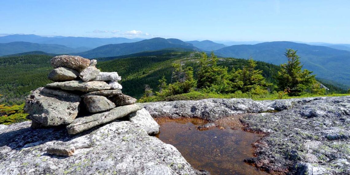 photo of a cairn of stones on a moutaintop
