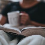 Photo of person with coffee mug reading the Bible