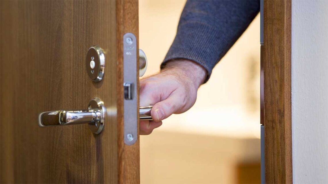 Photo of hand on doorknob closing door