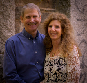 Photo of Pastor Ric and KD in front of a stone wall