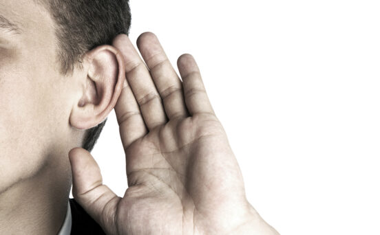 photo of person listening hand to ear