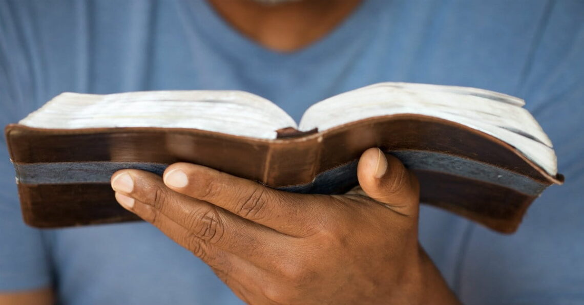 photo of person holding a Bible in their hand
