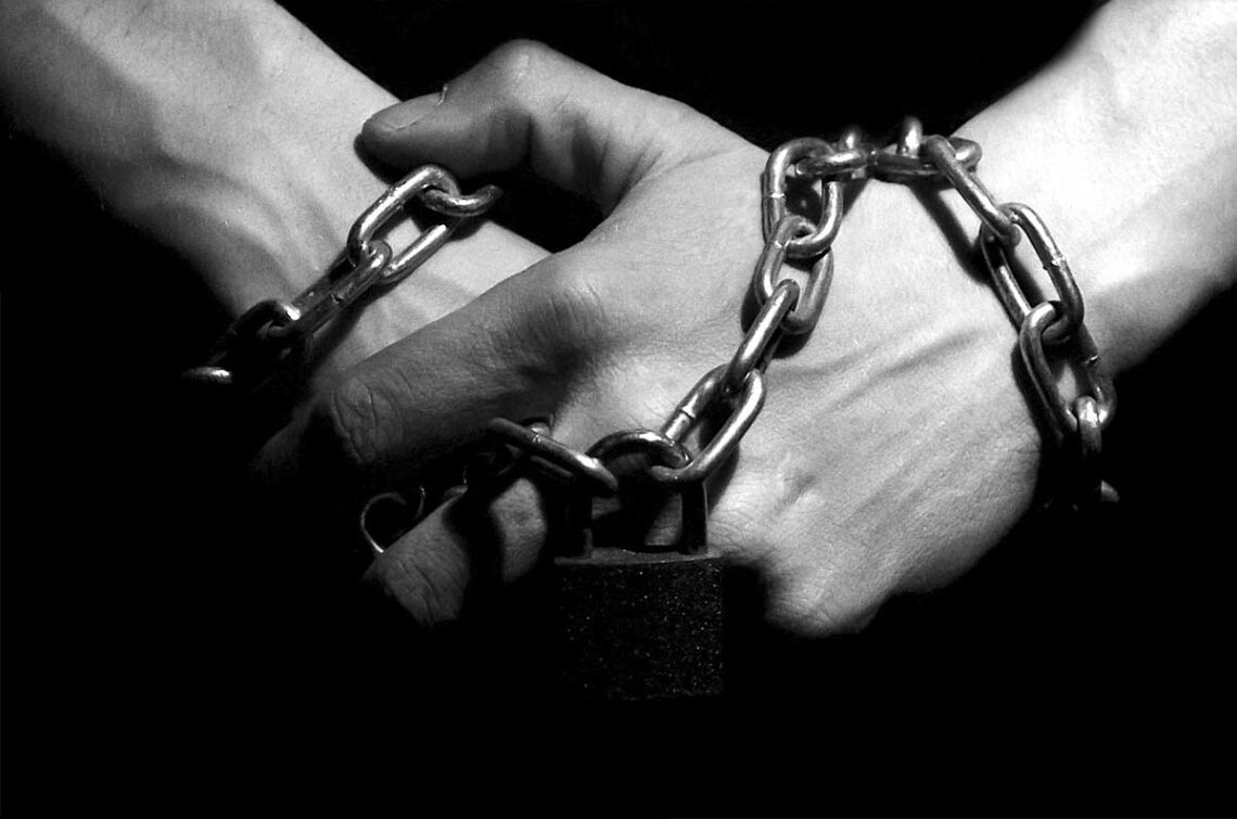 photo of clasped hands in chains