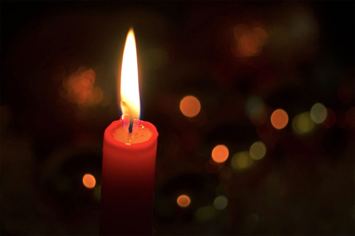 photo of a red, burning, Christmas candle