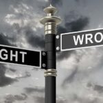 Photo of street signs that say right and wrong