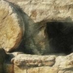 photo of a circular stone outside an open tomb