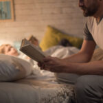 photo of a father reading a good night story to his son