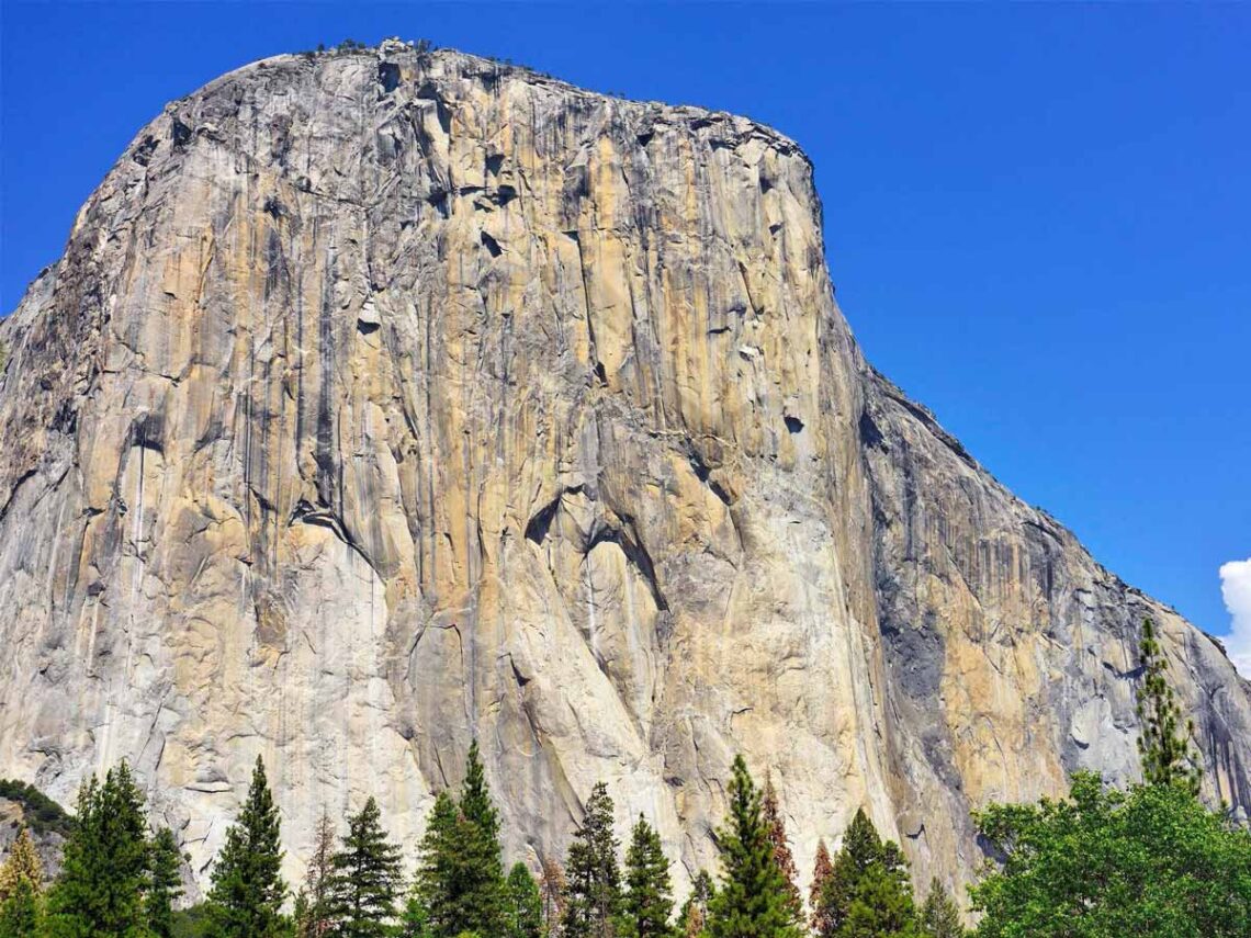 photo of the rock formation El Capitan in the sun against a bright blue sky